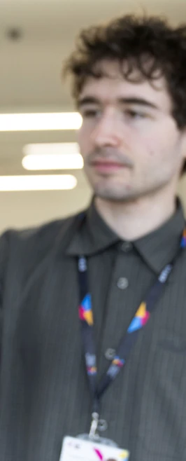 Person holding a small, unfinished ceramic bowl in an art studio with easels in the background. Person holding a small, unfinished ceramic bowl in an art studio with easels in the background.